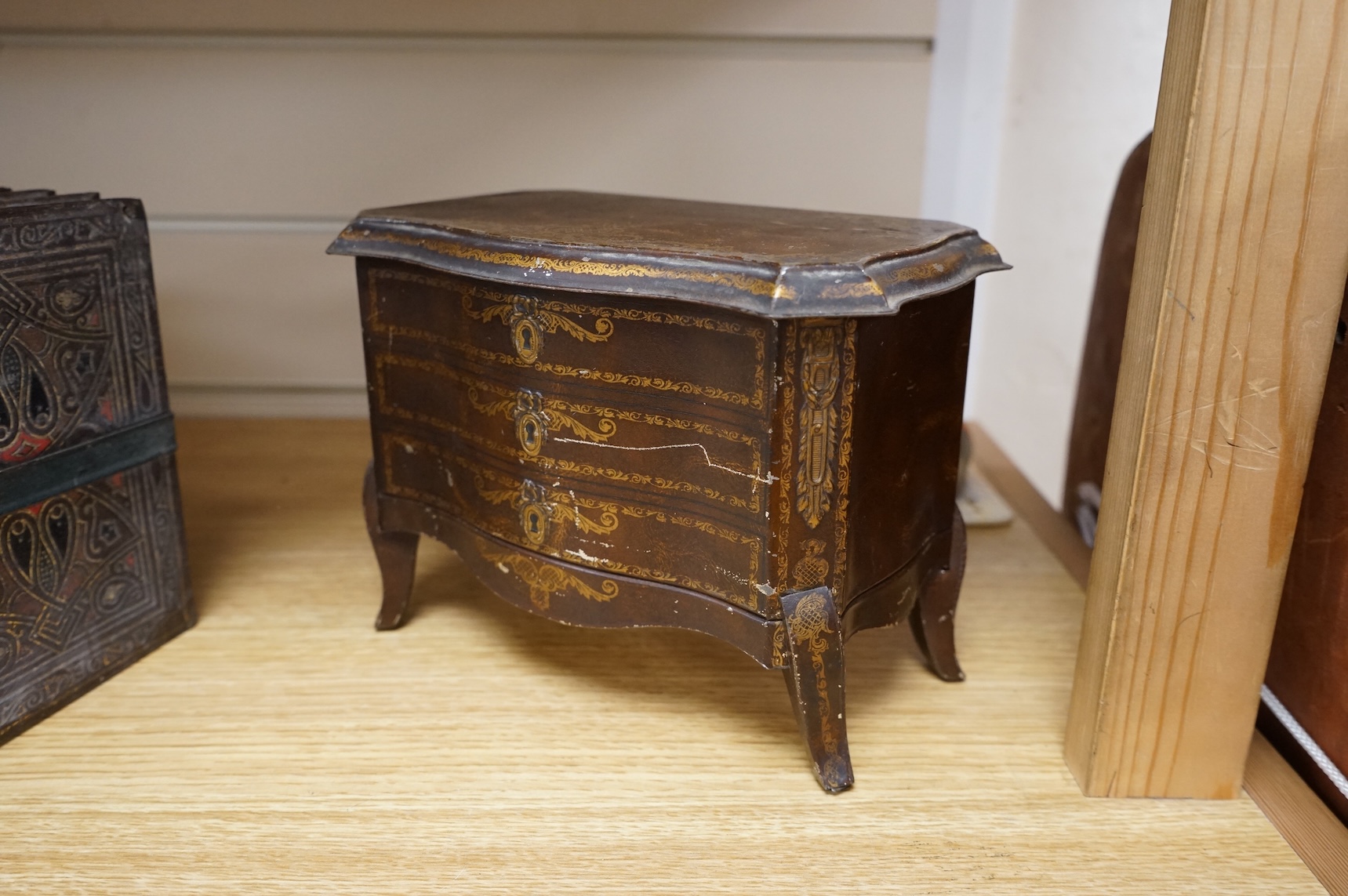 A Huntley and Palmer biscuit tin, modelled as a set of books and and two Mcvitie and Price tins modelled as French chests, tallest 16cm